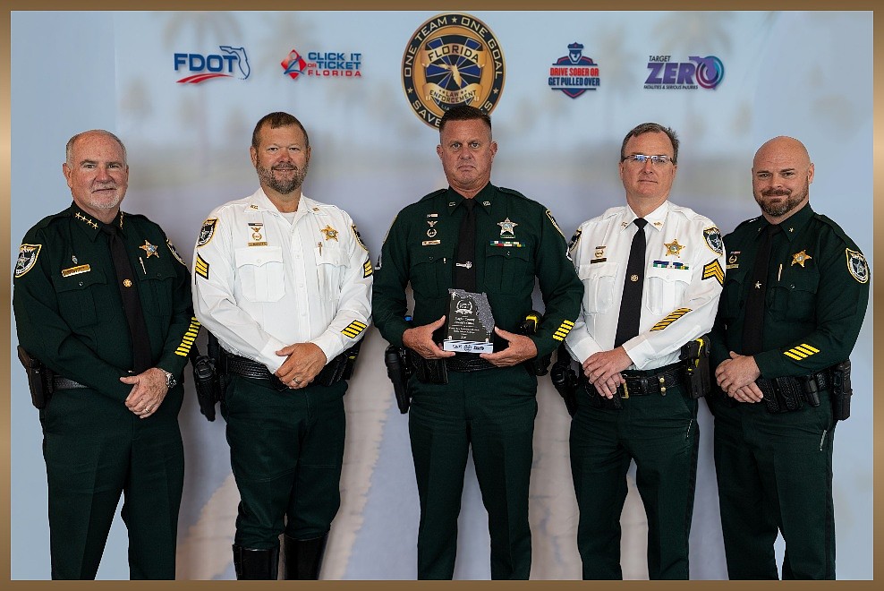 Sheriff Rick Staly, Sergeant Chris Ragazzo, Master Deputy Greg Nunziato, Sergeant Adam Biss, and Commander Jon Dopp pose with the 2026 Florida Law Enforcement Traffic Safety Challenge Award, July 31, 2026, in Orlando.