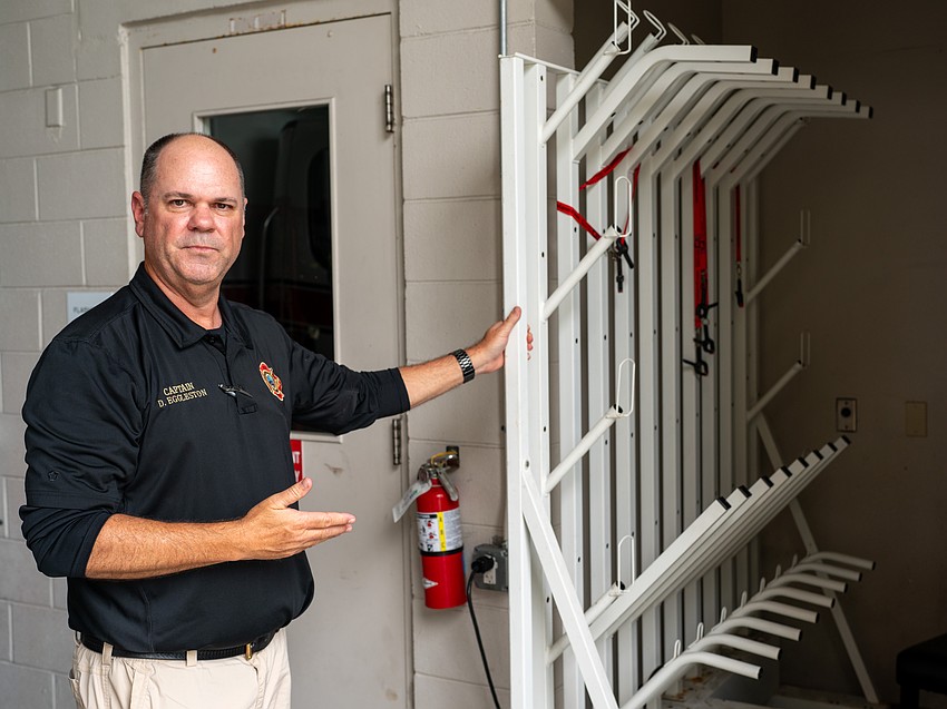 Longboat Key Fire Rescue Training Captain David Eggleston shows the drying rack reserved for fire ensembles, which are washed and dried separately because of the contaminants they can accumulate during fires.