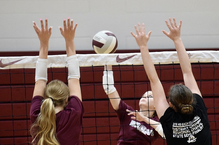 Rising sophomore Claire Barrett (left) and rising freshman Makinley Kane (right) try to block an attack by junior varsity's Taryn Norton (center). Rising sophomore Claire Barrett (left) and rising freshman Makinley Kane (right) try to block an attack by junior varsity's Taryn Norton (center).