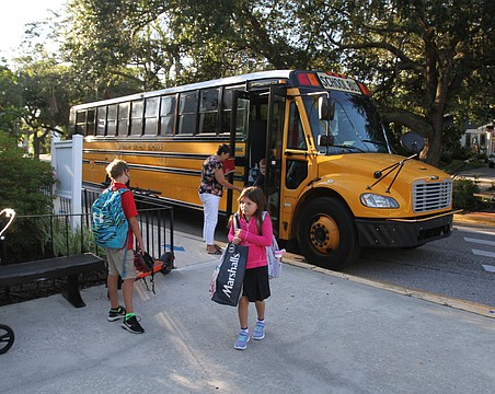 Kids arrive by bus at Southside Elementary. School begins Monday in Sarasota County.