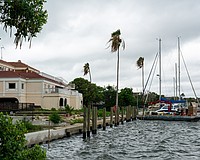 Workers install boat slips behind the vacant lot where the Buccaneer Restaurant is planned. Additional slips will be installed behind the Harbor Square office building pictured left.