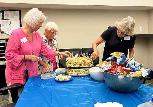 Sandra Johnson, Connie DiMaggio and Linda Theuer put finishing touches on the lunch they and fellow Longboat Island Chapel volunteers provided to Longboat Island Police officers on Thursday. It is Longboat Key Fire Rescue's turn on Wednesday.