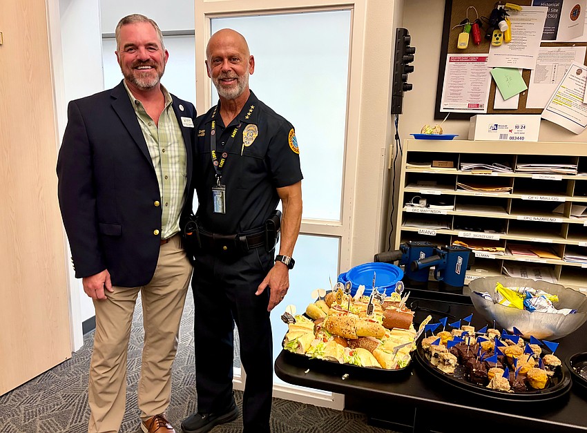 Longboat Police Chief Russ Mager thanks Longboat Island Chapel Rev. Brock Patterson for his congregation's efforts to coordinate a lunch for officers.