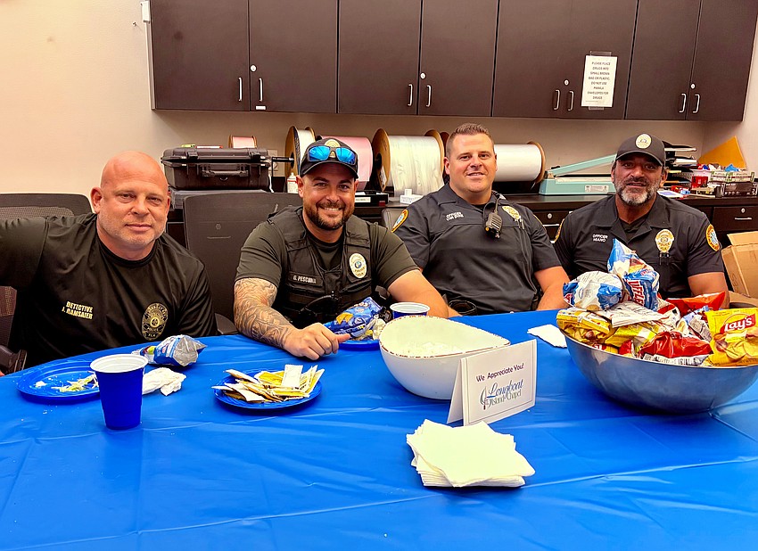 Justin Ramsaier, Gregg Pescuma, Andrew Van Dyke and Al Miano of the Longboat Key Police Department sit down to lunch with community members.