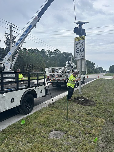 Volusia County Road and Bridge traffic signal maintenance crews work to prepare the school zone traffic control devices. Courtesy photo