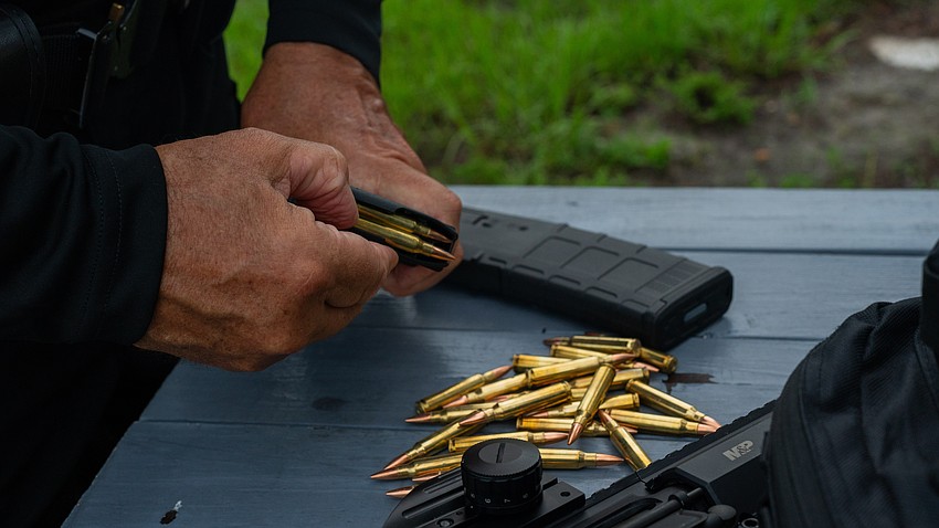 Longboat Key police officer Dexter Nazareno unloads an assault rifle magazine at the old Bradenton Police Department gun range Thursday, Aug. 6.