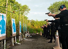 Longboat Key police officers aim at the target before performing state-mandated annual firearm training Thursday.
