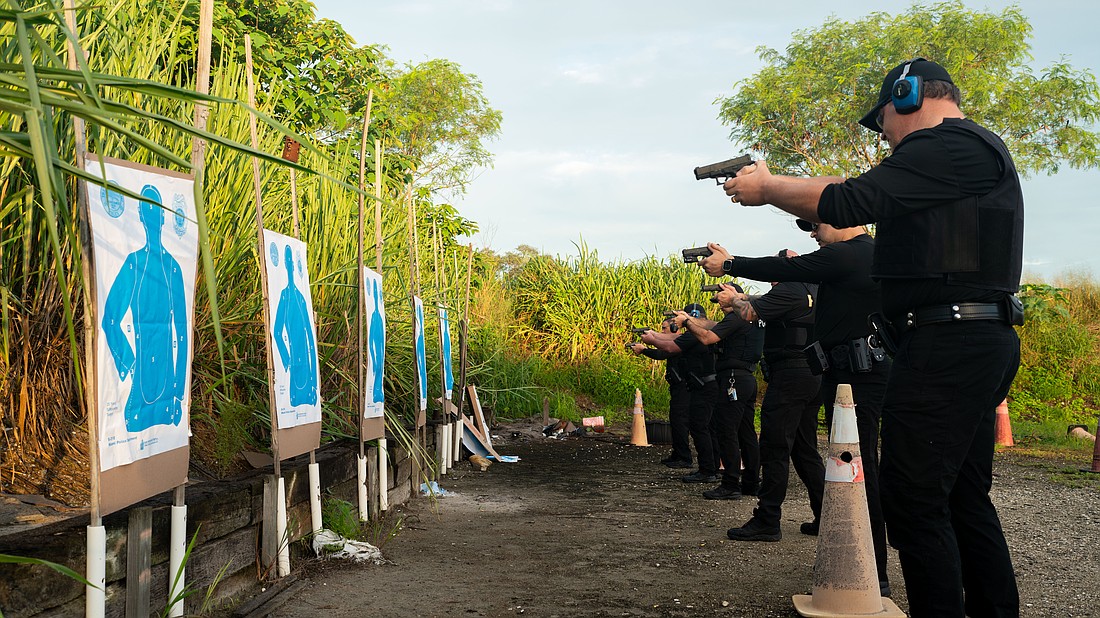 Longboat Key police officers aim at the target before performing state-mandated annual firearm training Thursday.