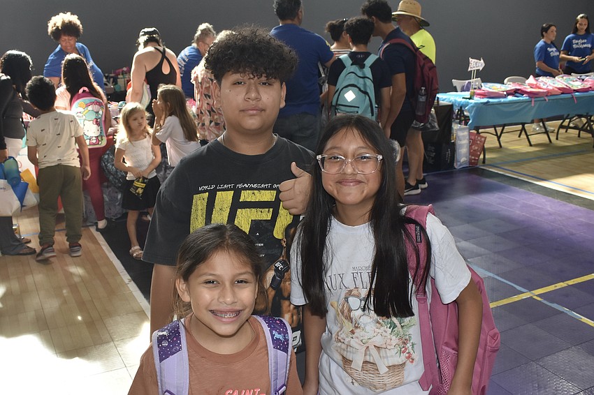 Elena Chavez, 8, her brother Elijah Chavez, 13, and their cousin Grace Garcia, 10, showcase some new materials.