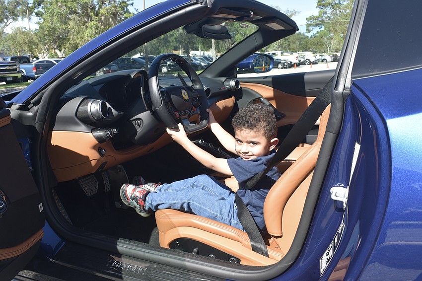Michael Tavros, 3, takes the driver's seat in an 812 GTS Ferrari.