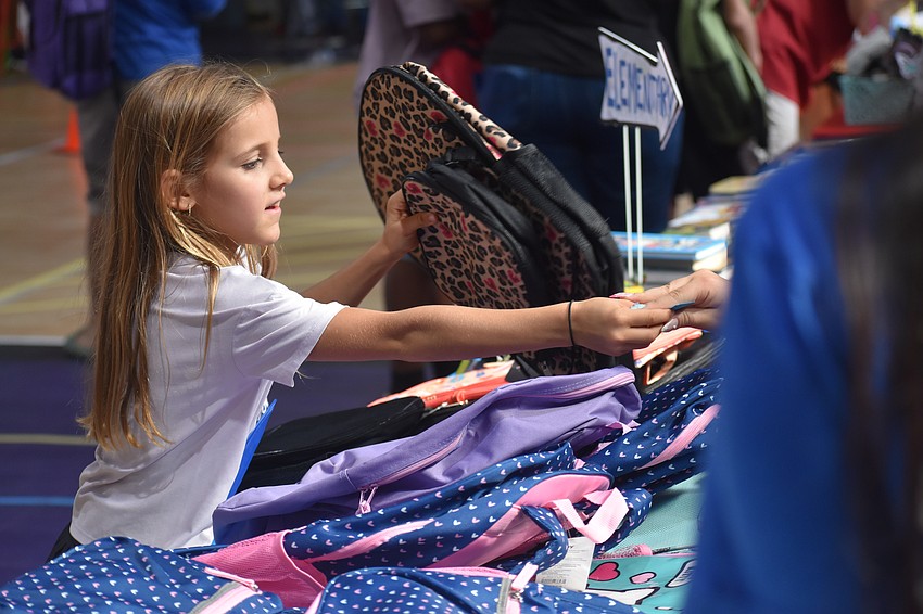 Elise Vovkulin, 7, chooses her favorite backpack.