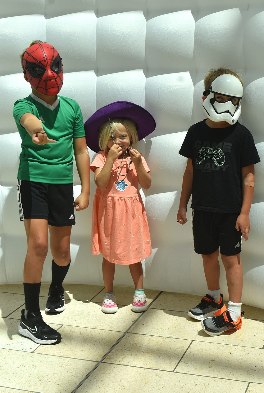 Nokomis residents Parker Hadrava, Nina Hadrava and Jasper Hadrava strike a pose at the Back to School Bash at The Mall at University Town Center Aug. 8.
