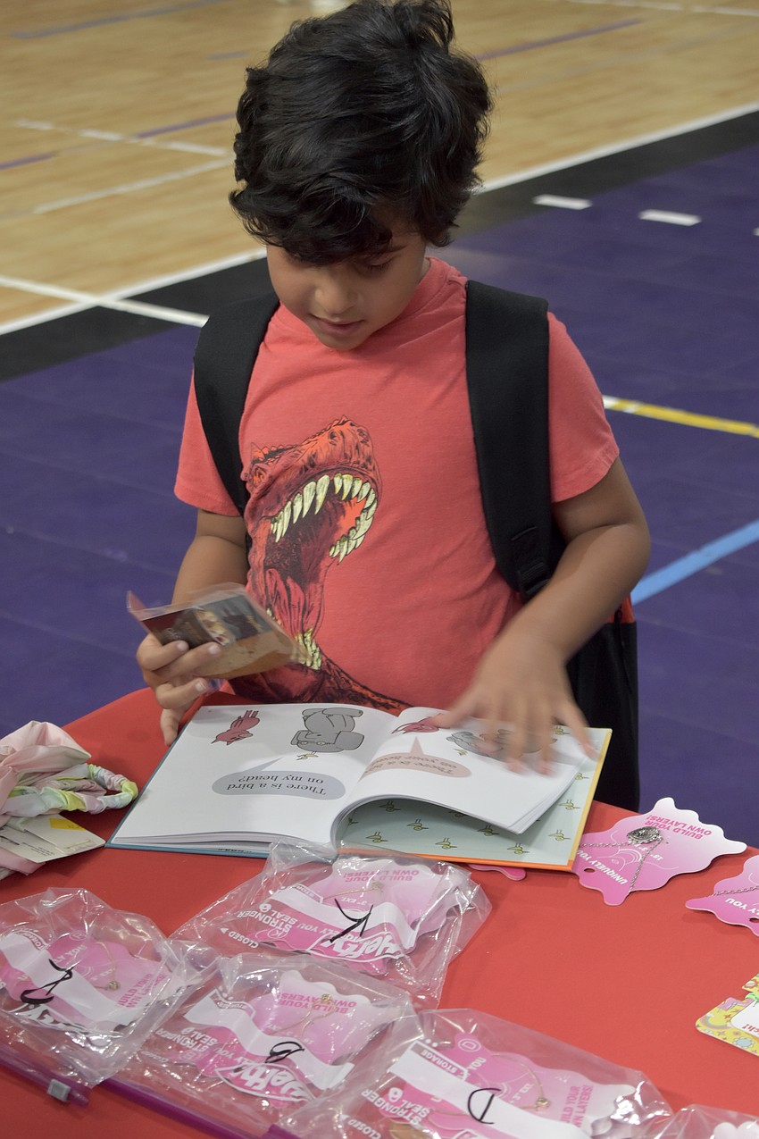 Diago Fernandez, 8, takes a look at a new book he received.
