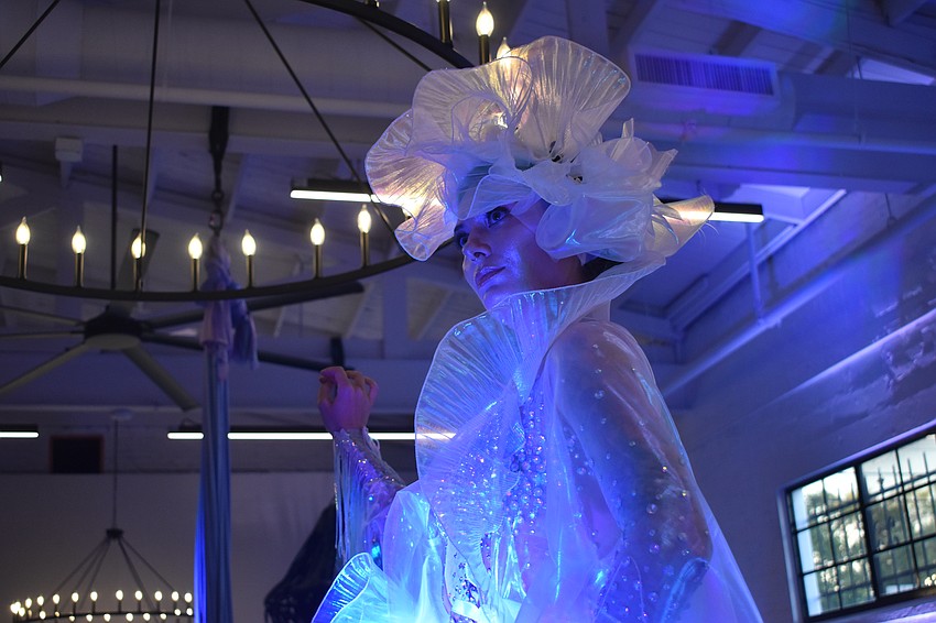 Living sculpture and dancer Carmen Lai Garden poses as guests mingle at the event.