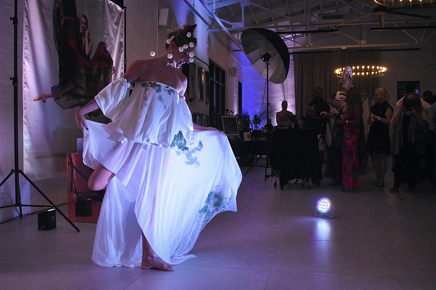 Sarasota's Yuliya Suvalava, a living sculpture, shows off her painted dress.