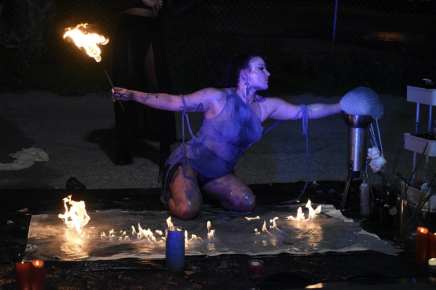 St. Pete aerialist, fire performer and artist Mala Vavourakis uses fire to fill out a canvas.