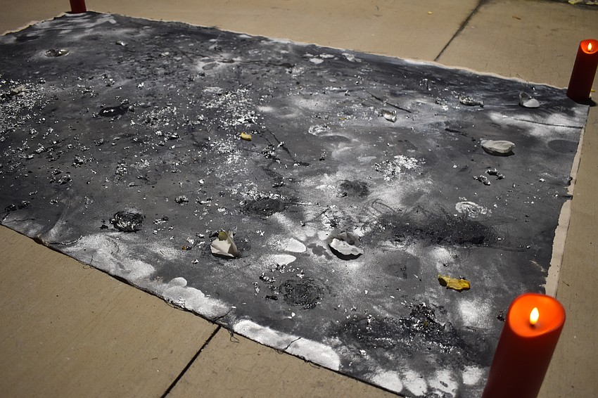 St. Pete aerialist, fire performer and artist Mala Vavourakis created a grey piece in honor of Stephanie Grae. She said her work is typically blues or purples with a celestial theme.