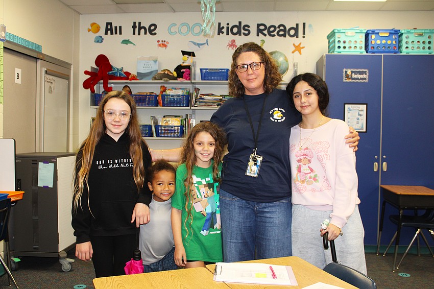 Fifth-grade teacher Rebecca Henry greets former student Nahomy Mejia, right, while also welcoming new students for a 'Meet the Teachers' night at Alta Vista Elementary School. Laci Jones, 12, is going into seventh grade, Noah Murphy, 5, is starting kindergarten, and Lily Jones, 10, is entering fifth grade.