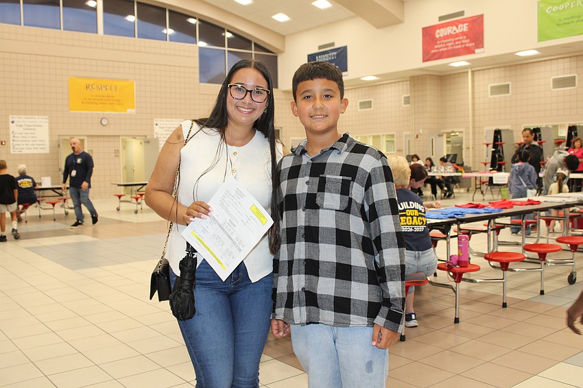 Katty and Sebastian Marquez go over schedules before the first day of school at Alta Vista Elementary School.