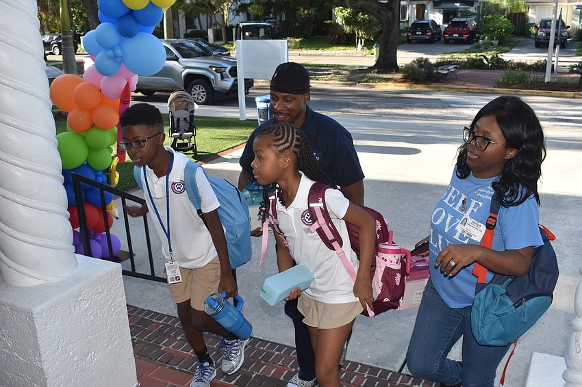 Jemier Whatley Jr., a fifth grader; his father Jemier Whatley Sr.; sister Harper Whatley, a third grader; and mother Tishawnna Whatley, head inside Southside Elementary.