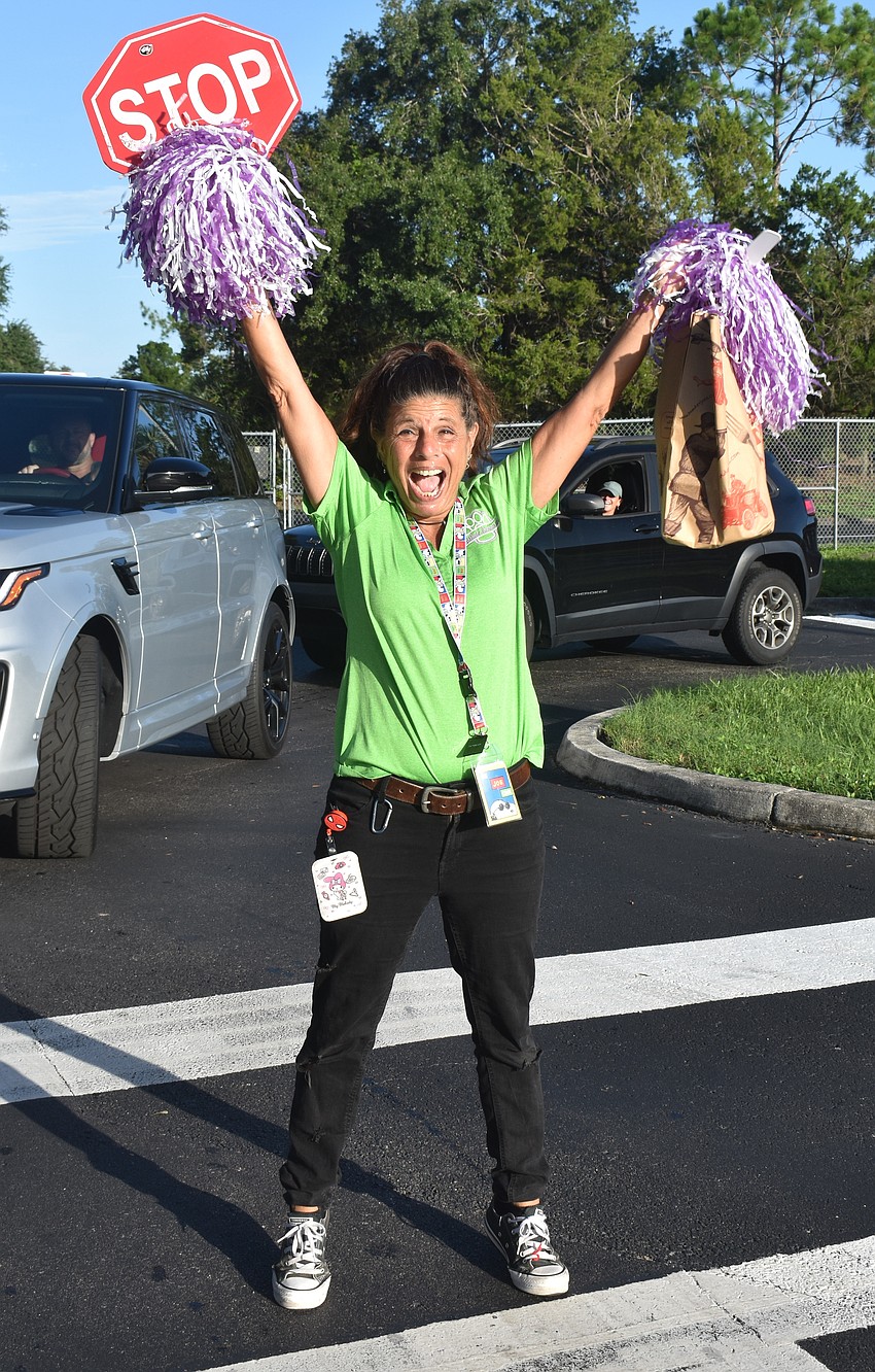 Paraprofessional Jo Gnad, who doubled as a crossing guard and cheerleader on the first day of school at McNeal Elementary, can't hold back her excitement for the new school year.