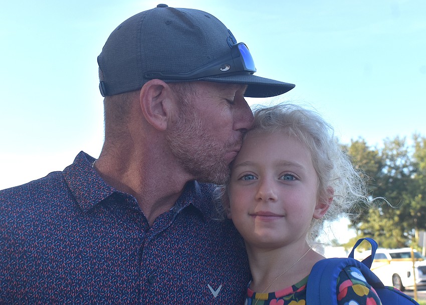 Aaron Herschberger wishes his daughter, Maya, a good first day of kindergarten at McNeal Elementary.