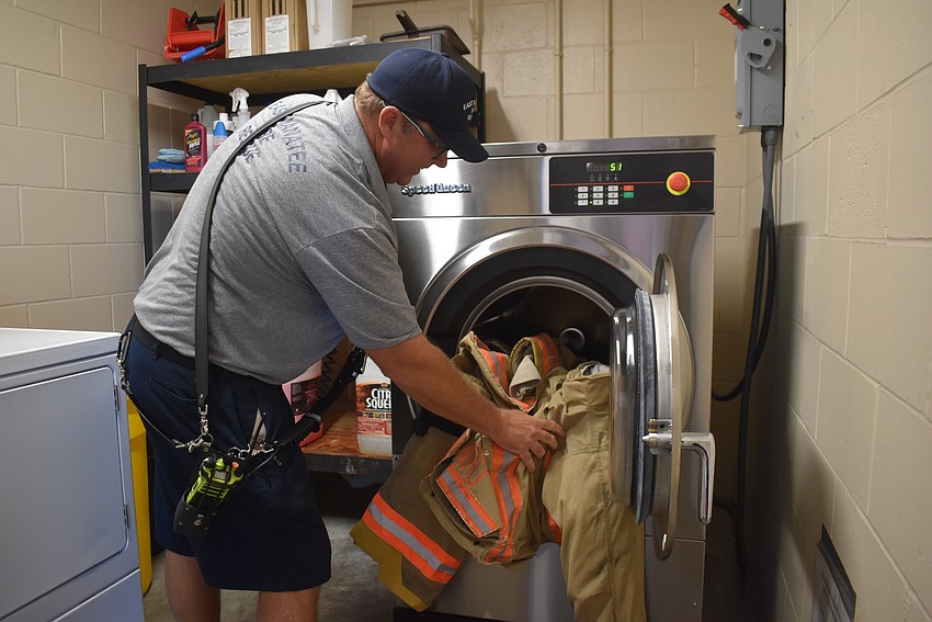 East Manatee Fire Rescue's Lieutenant Jack Gamble washes bunker gear at Station 1 in Lakewood Ranch. Bunker gear is made with PFAS for its ability to repel water, oil and heat.