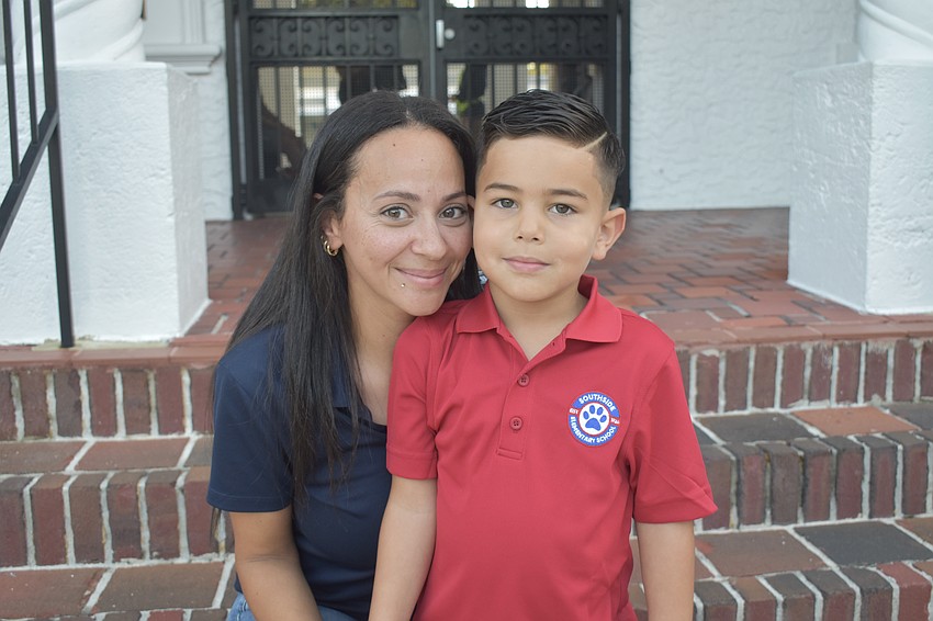 Aya Omar sits on the steps of Southside Elementary with her son Zayn Abdelrahim, as he prepares to start kindergarten.