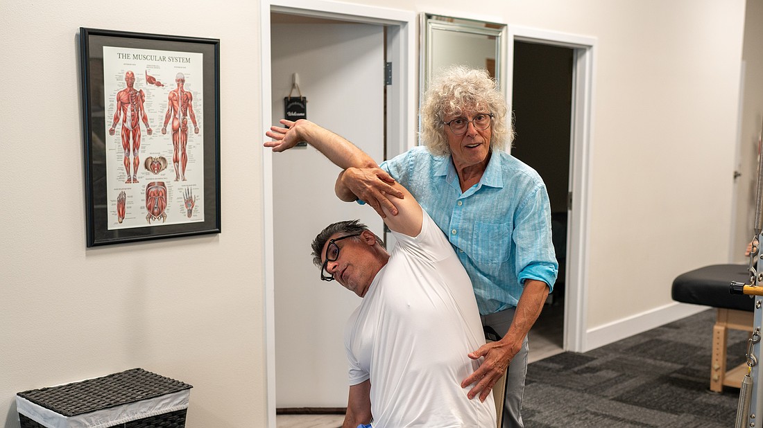 Chris Watts stretches Petar Sibinkic in the newly-expanded Longboat Key Fitness studio at 511 Bay Isles Pkwy.