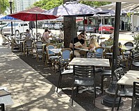 Diners have lunch at one of the restaurants offering street-side seating on Main Street.