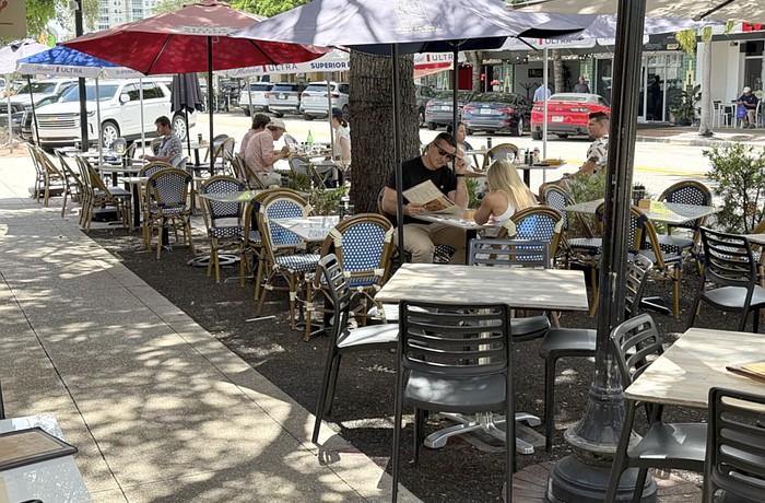 Diners have lunch at one of the restaurants offering street-side seating on Main Street.