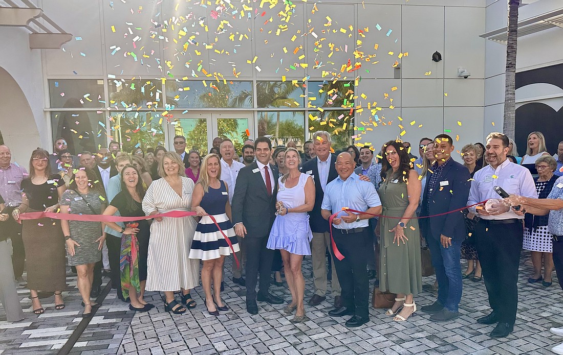 Confetti falls as the Greater Fort Myers Chamber of Commerce celebrates the opening of its headquarters at Collaboratory in Fort Myers.