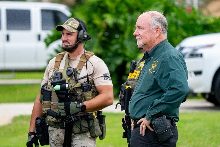 Commander Brian Finn and Sheriff Rick Staly look on during the search warrant served in Palm Coast, Fla., Thursday, Aug. 6, 2026. Photo courtesy of the Flagler County Sheriff’s Office